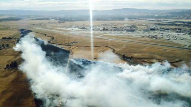 Grass fire at Travis Air Force Base nearly contained