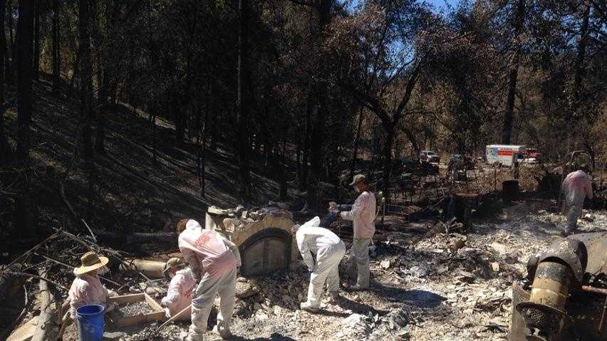 HazMat volunteer crews help Butte Fire victims sift through the remains of their homes on Wednesday.