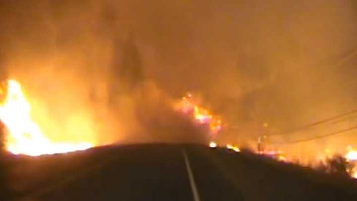 Dash camera video from Lake County sheriff's deputies shows flames and smoke from the Valley Fire crossing the roadway in front of the deputies' patrol car.