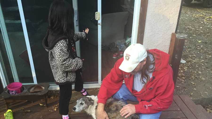 Kirk Fetter pets his dog Tiki on Thursday, Oct. 29, 2015, the day after Tiki was attacked.