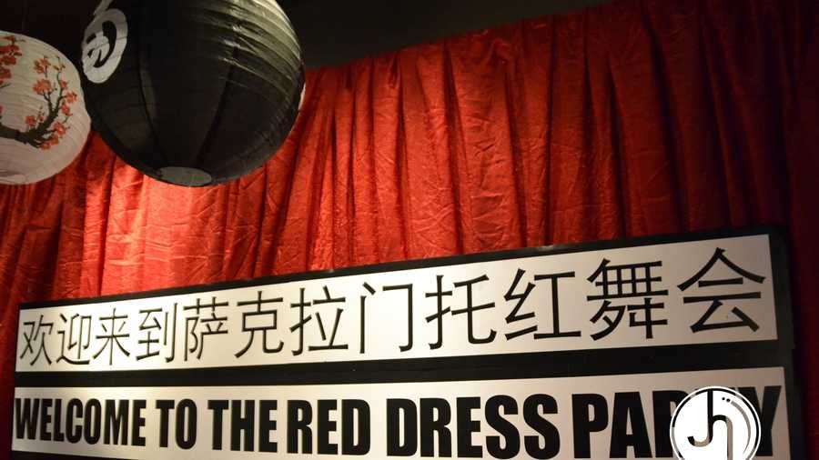 Sign at that hung at the Sacramento Red Dress event. Sacramento Asian Pacific Islander groups spoke out against the "Red Dragon" theme, calling it offensive. (PHOTO: Jana Hendler Photography)
