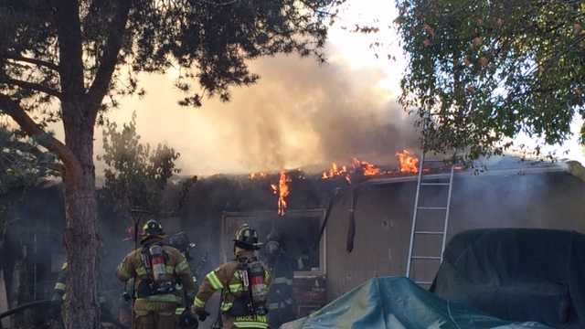 Sacramento Metro firefighters battle a blaze at two North Highlands homes on Tuesday, Nov. 10, 2015.