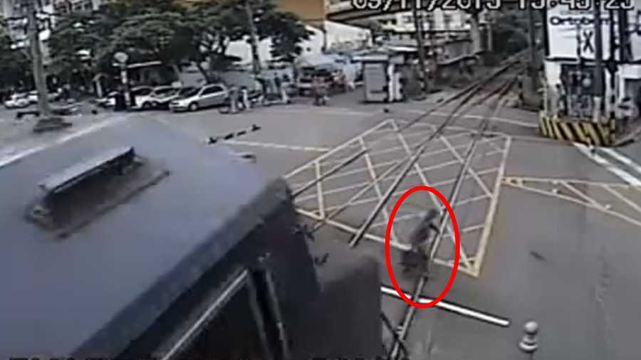 Elderly man seen on surveillance camera nearly gets hit by train in Brazil. Photo is a screen grab of the video.