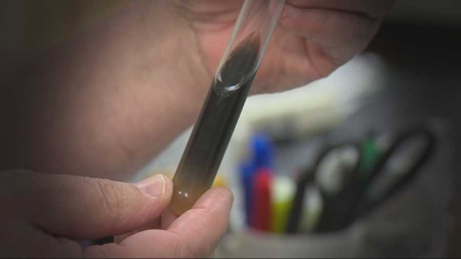 A lab technician holds up a test tube showing the results of a swab sample taken from a Sacramento RT elevator.  The technician said the concentration of fecal streptococcus found in the sample is unhealthy and that the health department should be called.