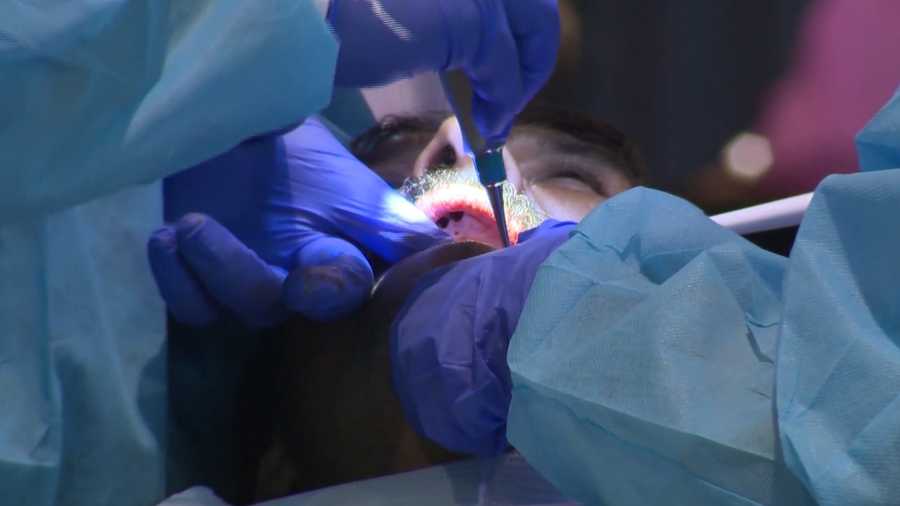 Man gets his teeth checked during dental check up.