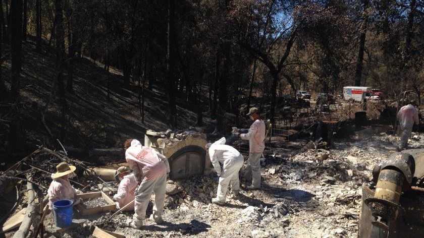 Crews worked to sift through hazardous materials that were left by homes destroyed in the Butte Fire.