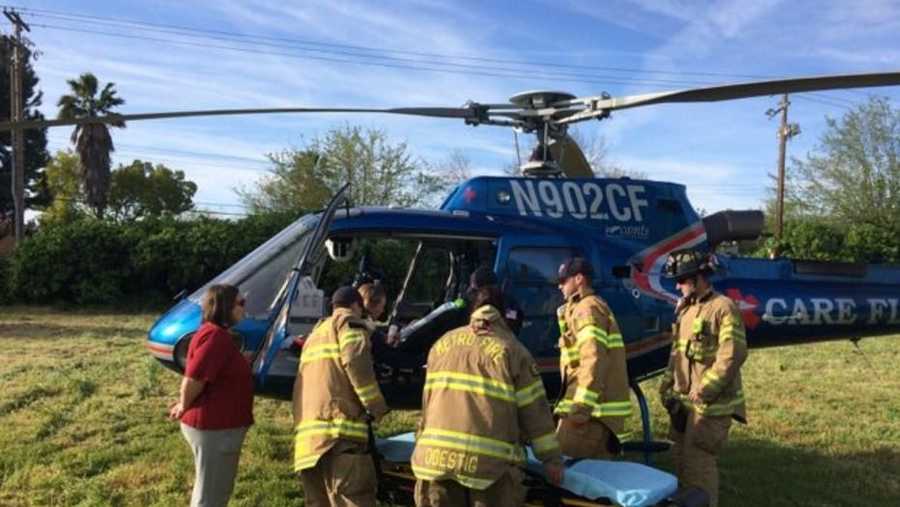 Sacramento Metro Fire crews assist a toddler who was being transported to UC Davis Medical Center on a helicopter after the aircraft made an emergency landing on Wednesday, March 23, 2016.