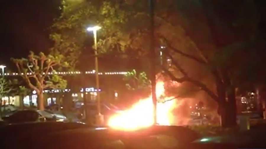 The video shows a car engulfed in flames in a Starbucks parking lot off Sunrise Boulevard.
