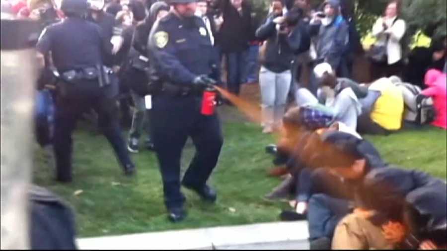 A UC Davis campus police officer pepper sprays student protesters in November 2011.