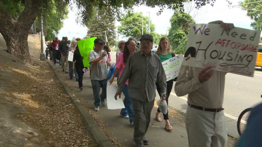 Homeless people and their supporters march along 12th Street in Sacramento.