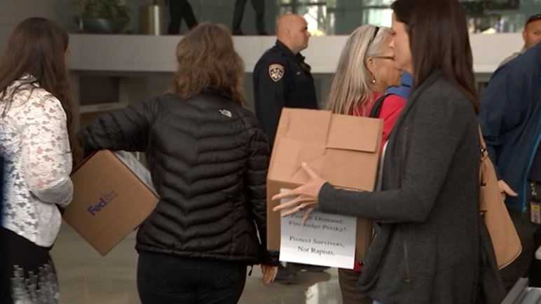 Critics of Judge Aaron Persky deliver boxes representing nearly a million petition signatures they say they collected calling for his removal from the bench.