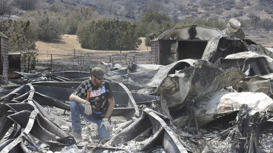 Lucas Martin stares at all that remains of his fire ravaged home in South Lake, Calif., Sunday, June 26, 2016. Martin's home was among the more than 200 homes and buildings destroyed by the fire that swept through the area near Lake Isabella, Calif.