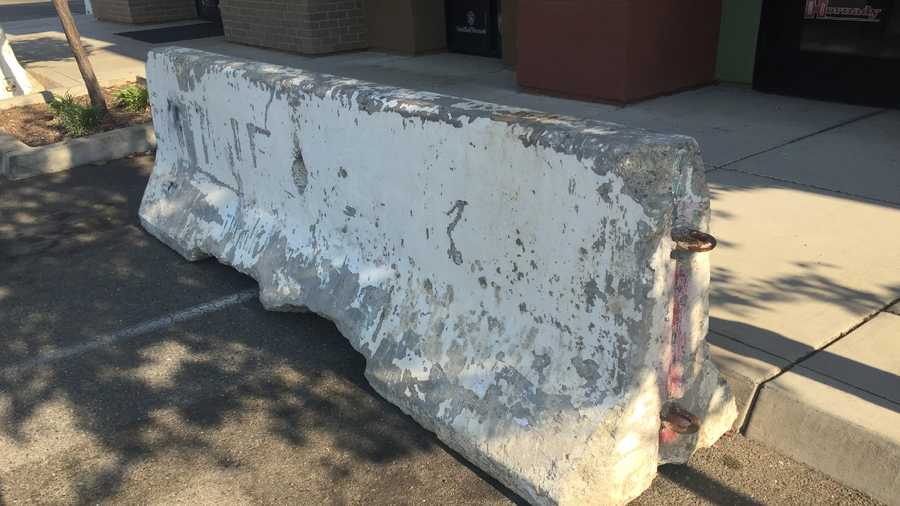 A Rocklin gun store owner put three cement barriers in front of his store and the city is asking him to remove them.