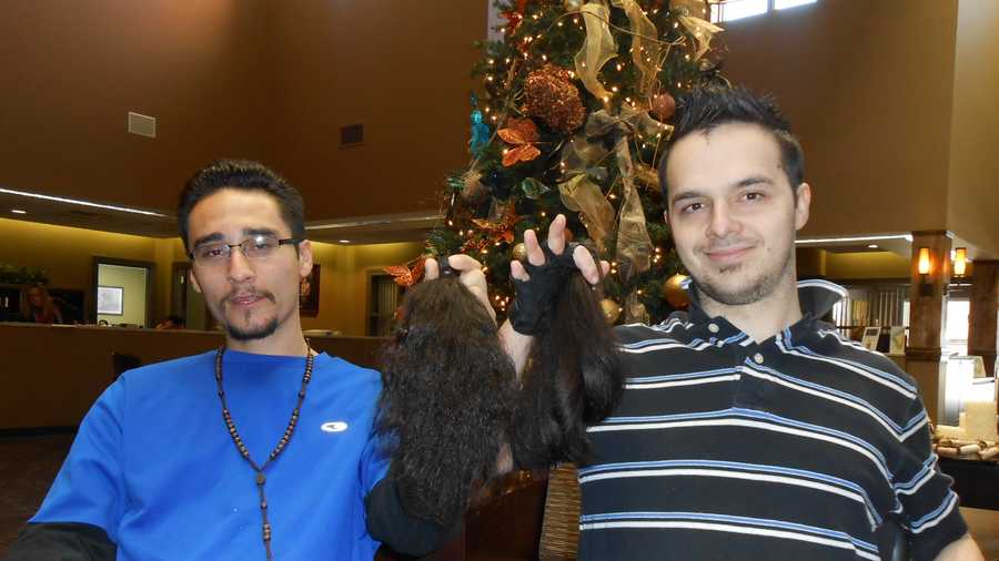 Dave Dominguez and Aaron Tanguis show off the hair they're donating to Locks of Love.  Great Clips provided free haircuts for both men.