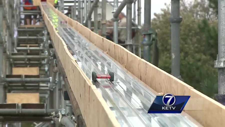 Boy scouts, carpenters, and local businesses come together to build the world's longest Pinewood derby track.