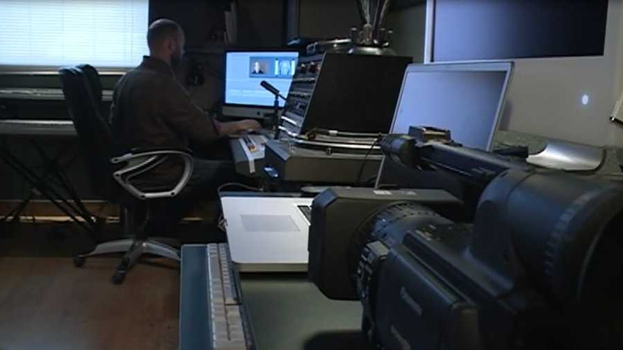 Dan Robinson, owner of Fiery Moon Productions, works on a locally produced documentary at his studio in Fayetteville. 