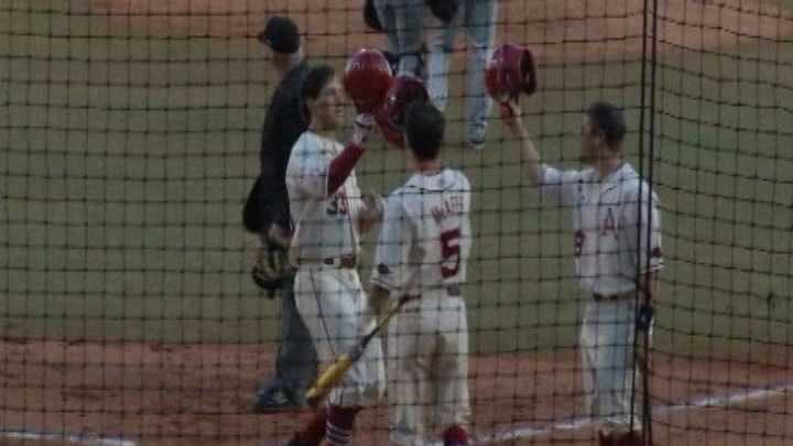 Arkansas' Krisjon Wilkerson celebrates at home plate after a home run.