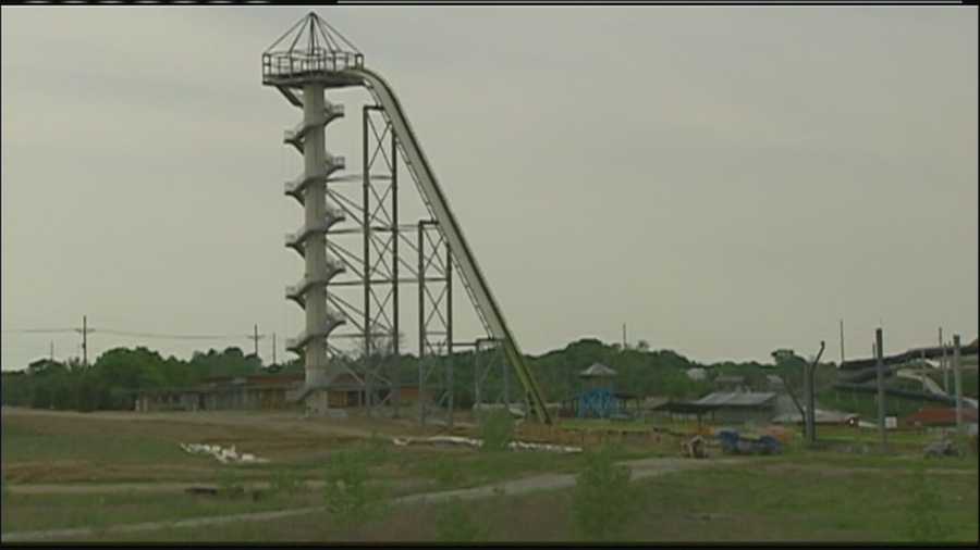 Workers at Kansas City Kansas' Schlitterbahn water park took part pieces of its 'Verruckt' water slide on Wednesday, delaying its opening for 10 days while it makes adjustments.