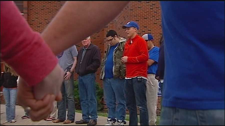 Friends and family members gathered Monday evening to pray for the recovery of a Royals superfan who was shot when he interrupted a burglary at his Independence home.