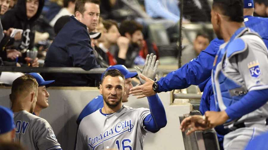 Kansas City Royals' Paulo Orlando (16) is greeted by his teammates after scoring against the Chicago White Sox during the sixth inning of a baseball game, Friday, May 20, 2016, in Chicago. (AP Photo/David Banks)