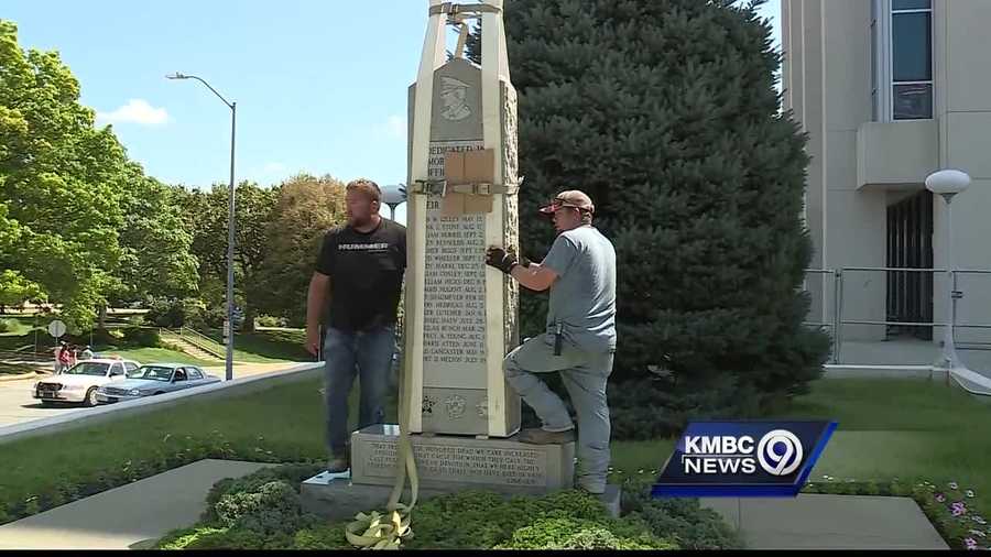 A memorial to Kansas City, Kansas, officers who died in the line of duty is returned to its original location outside City Hall.