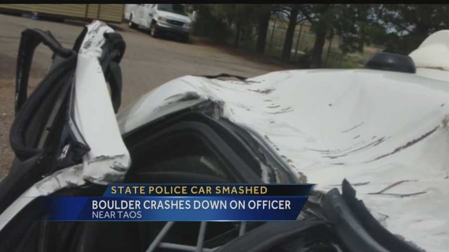 Boulder crashes down while officer was driving