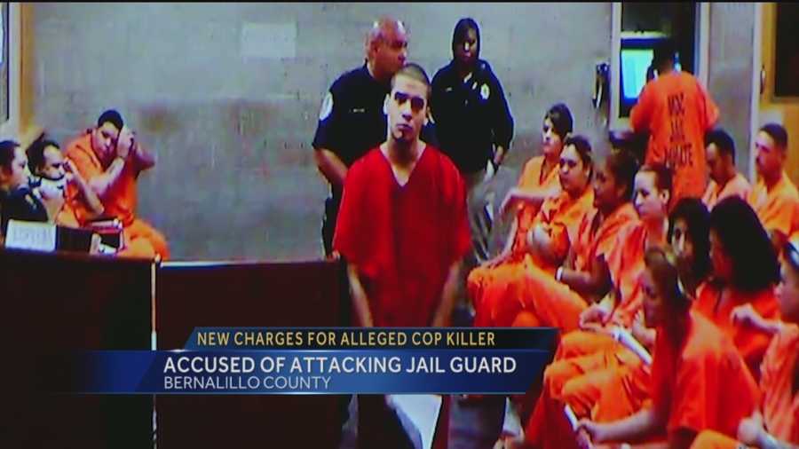 The man accused of murdering a Rio Rancho Police Officer is now also charged with attacking a jail guard.