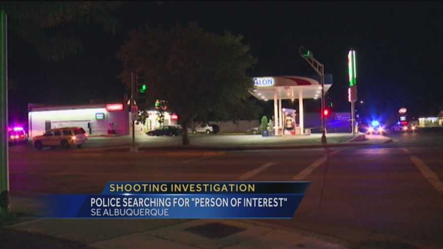 Police are searching for a person of interest after two people were shot outside a southeast Albuquerque gas station.