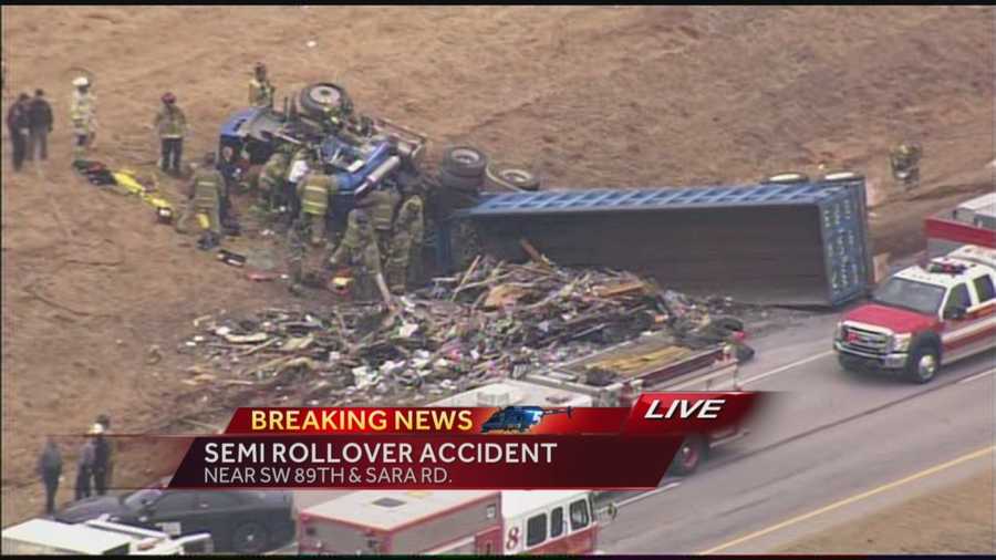 Crews are working to free a person trapped by an overturned tractor trailer.