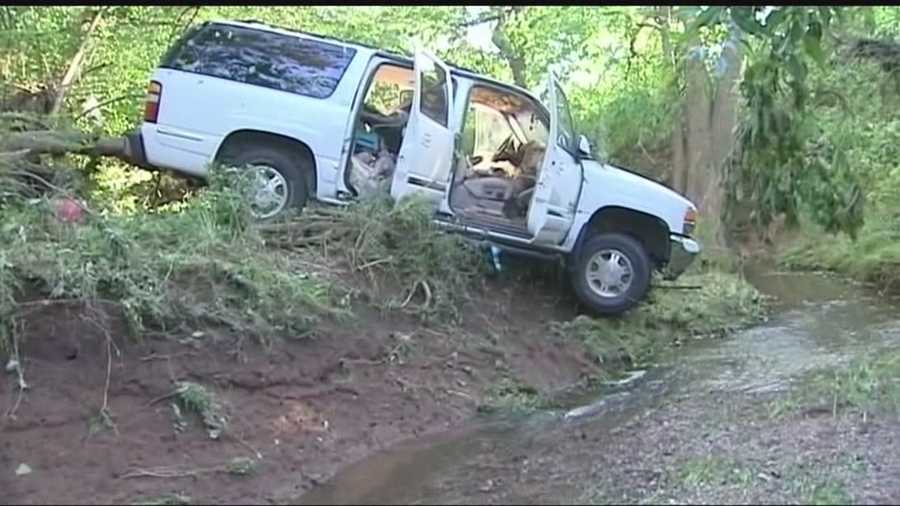 The vehicle was forced into a creek after heavy rains.