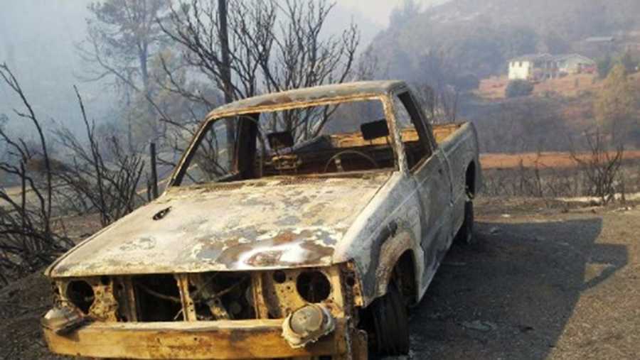 A truck is burned out from a wildfire in Lake County. 