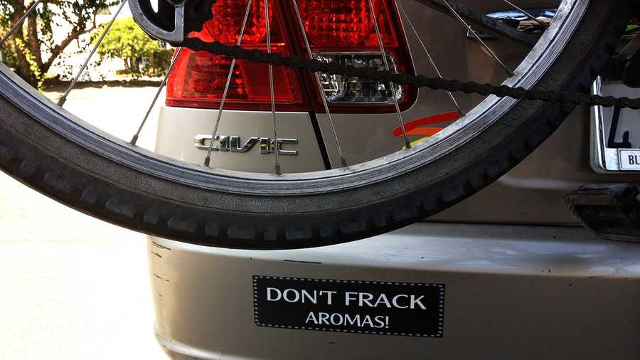 A bumper sticker on a car parked in Santa Cruz reads, "Don't Frack Aromas!" 