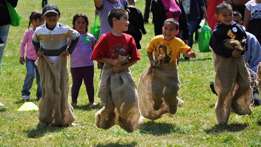 Kids have fun during a potato sack race in Watsonville.