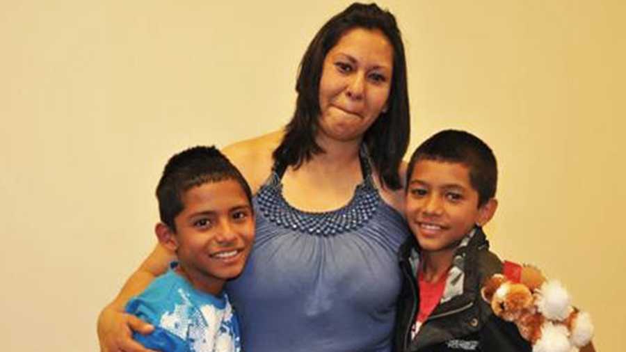 Sarani Hernandez beams after being reunited with her two sons. 