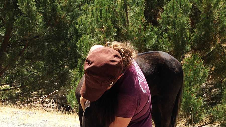 Candace Allen gives her little horse a big hug on Thursday. (June 13, 2013)
