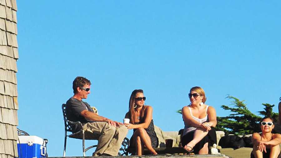 Friends hangout on a sunny rooftop near Pleasure Point in Santa Cruz. 