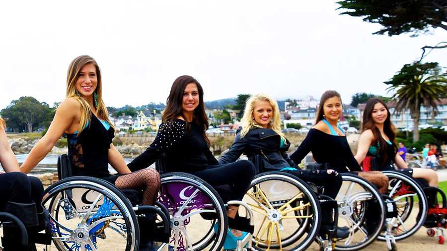Chelsie Hill, left, smiles with her wheelchair dance team, Walk And Roll Dance Team. 