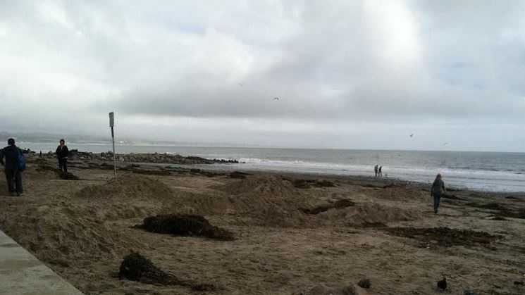 Cleanup began Sunday after a high tide swept over beach walls in Capitola.