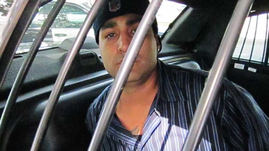 David Gomez, 30, of Santa Cruz, is handcuffed in the back of a patrol car. 