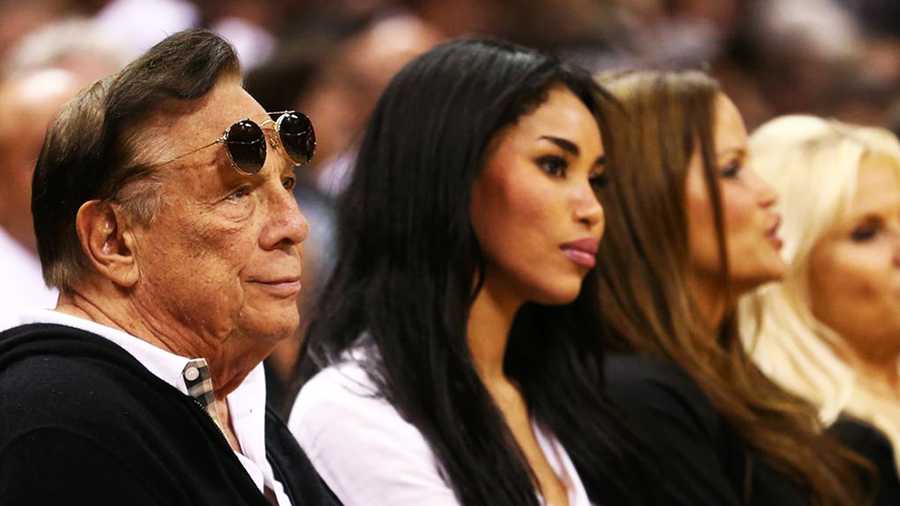 Donald Sterling, left, and his girlfriend, V. Stiviano, center, watch a Los Angeles Clippers game together. (May 2013)