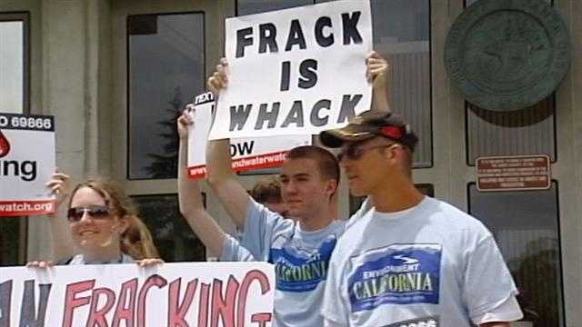 A sign reads, "frack is whack."