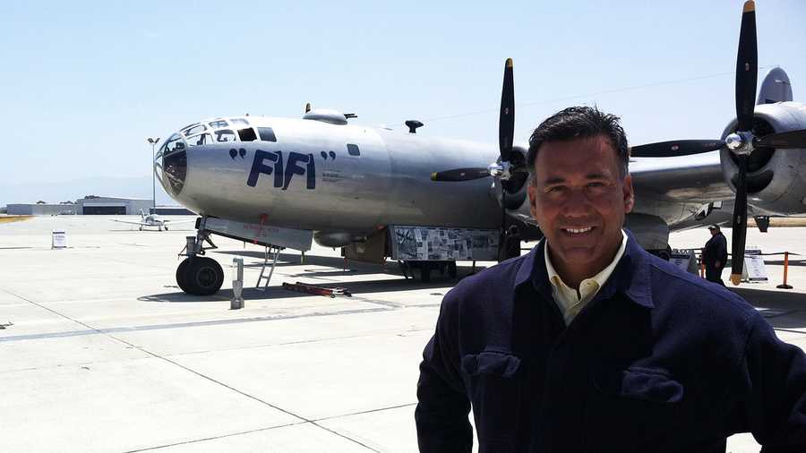 KSBW Reporter Felix Cortez stands next to FiFi the bomber plane in Salinas. 