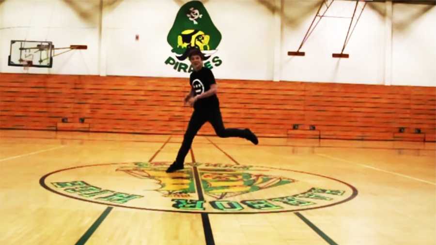 Evan Crowder, 15, break dances in the Harbor High School gym for "Happy."