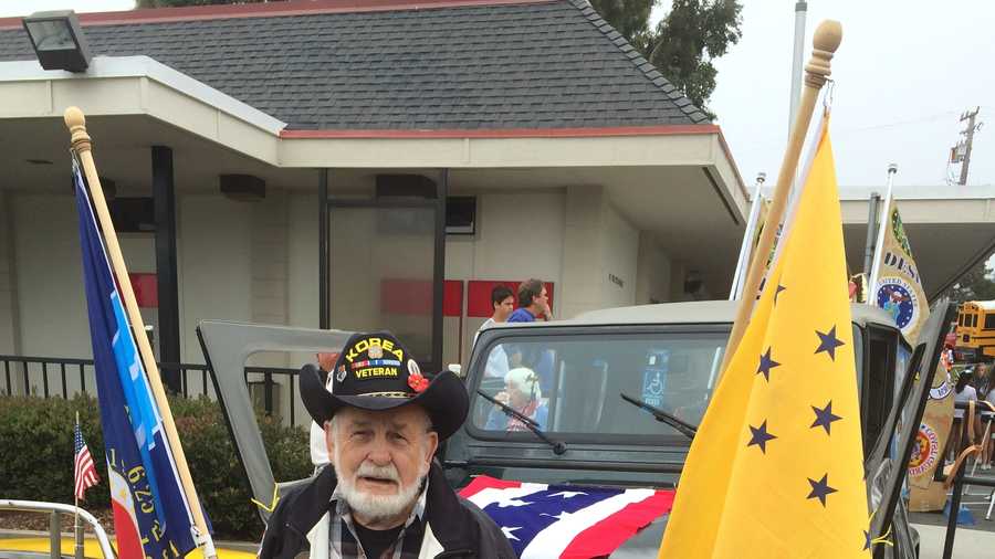 Korean War veteran Jim Brush poses with his jeep before Friday's World's Shortest Parade in Aptos