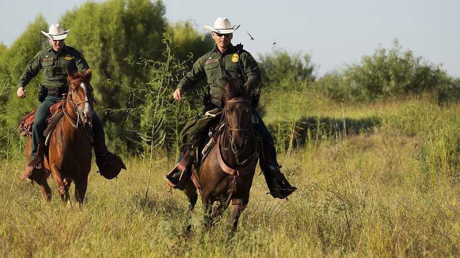 U.S. Border Patrol agents patrol the Mexico-US border on horseback in south Texas. 