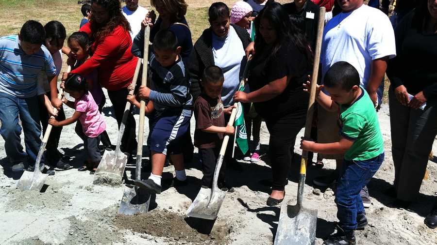 Kids break ground in Acosta Plaza for a new basketball court.  (Aug. 14, 2014)