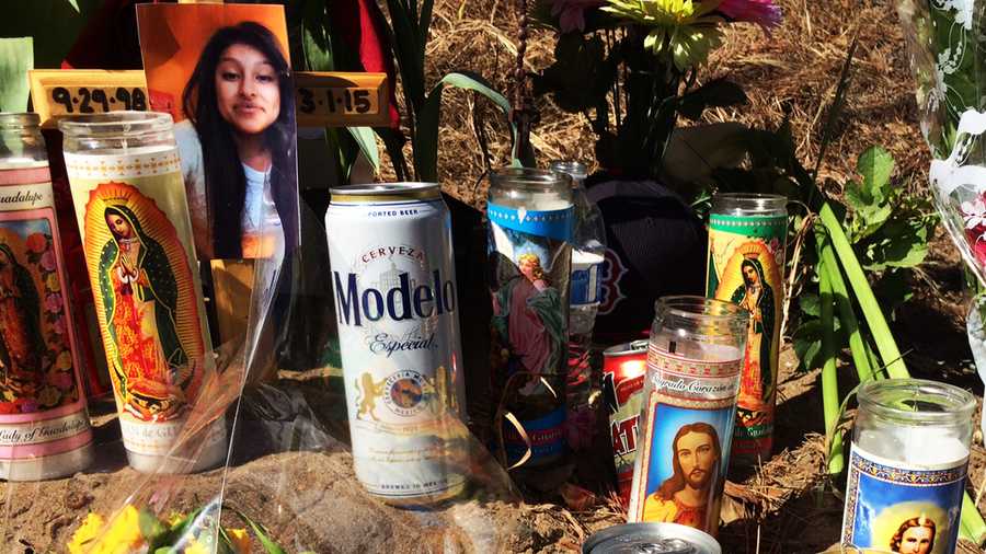 Beer cans were left among prayer candles where four died in Aptos.  (March 4, 2015)