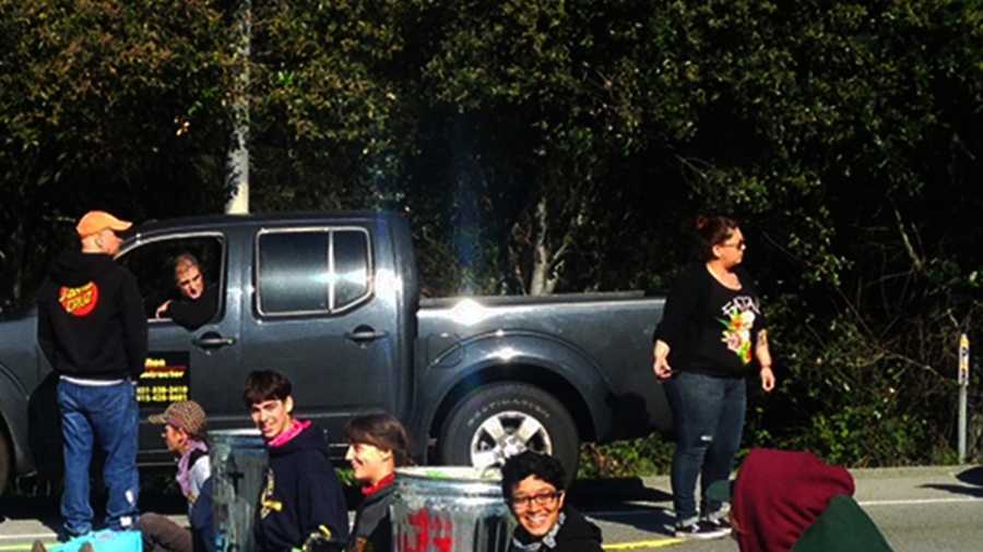 UC Santa Cruz students smile as they shut down Highway 1 with a human blockade. 