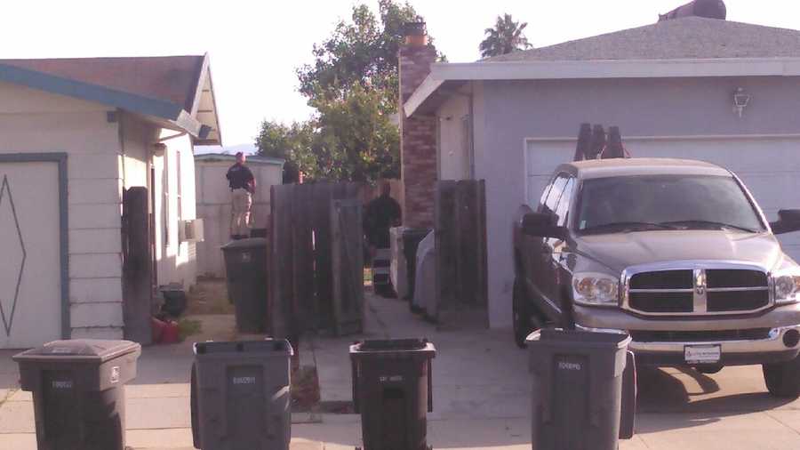 Salinas police surround a home where they believe murder suspect Brad Azcona is hiding