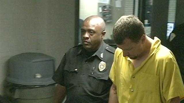 Man charged in double slaying makes tearful court appearance